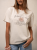 bluzka-tshirt-botanika-lemonada-jasny-beż-bawelna-98-elastan-kwiatowy-nadruk-botanique-lete-naturalne-piekno-premium-polskiej-produkcji-modna-bluzka-damska-wiosna-butik-szykownia-4